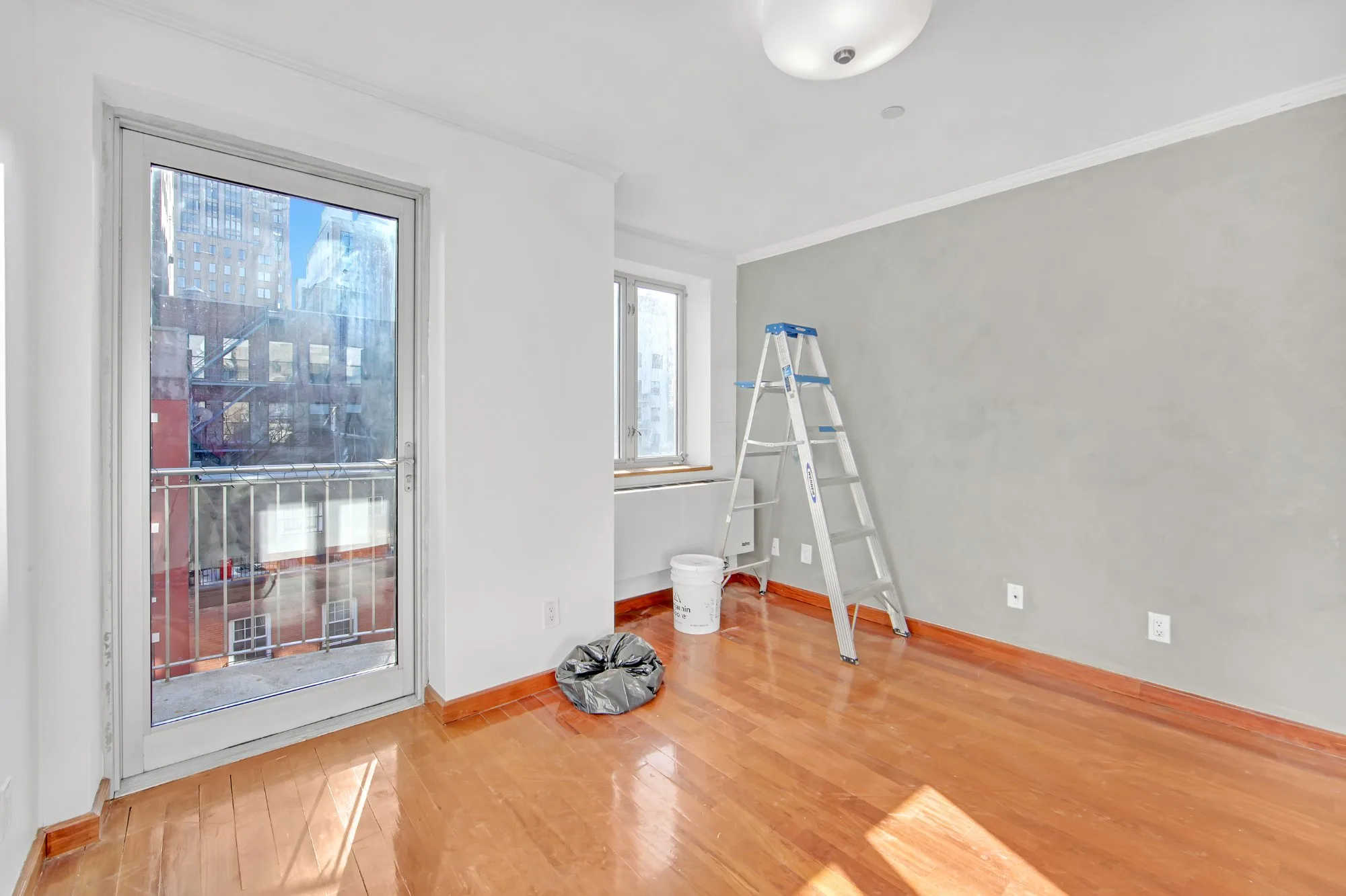 Before declutter - room with ladder and supplies
